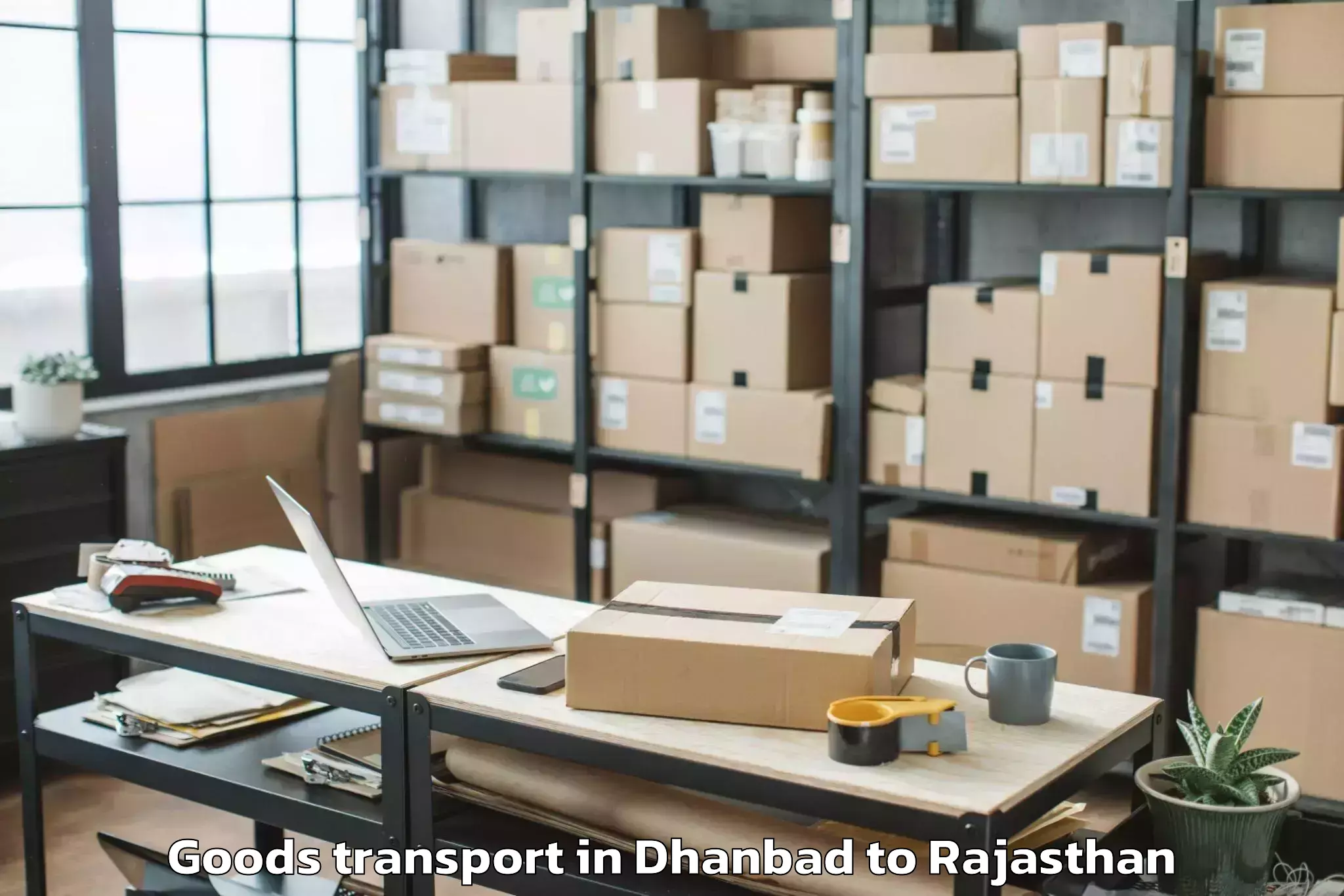 Book Your Dhanbad to Maharaja Ganga Singh Universit Goods Transport Today